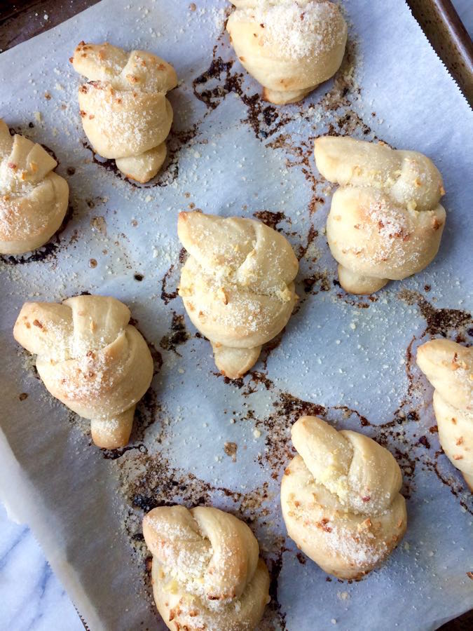 A pan full of yummy homemade garlic knots that taste just like your favorite pizzeria's!